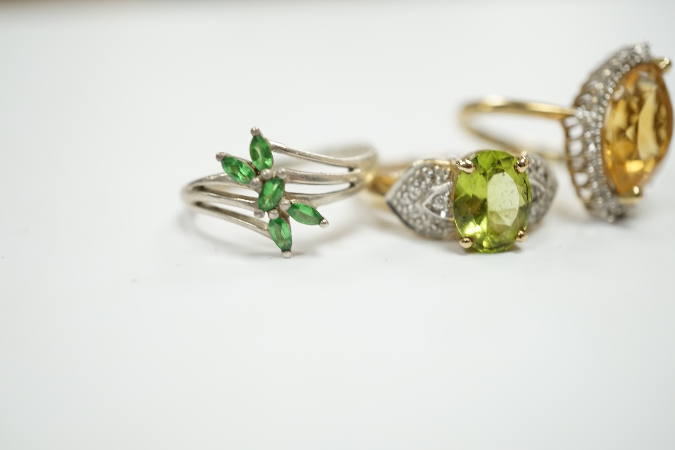 Two modern 9ct gold and gem set dress rings, including citrine and diamond chip and peridot and diamond chip, gross weight 8.2 grams, together with a 925 ring. Condition - fair to good